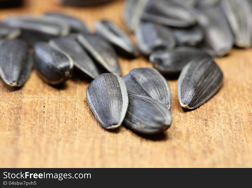 A lot of sunflower seeds on a wooden table