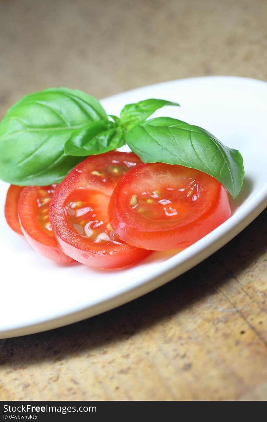 Tomato with basil on dish