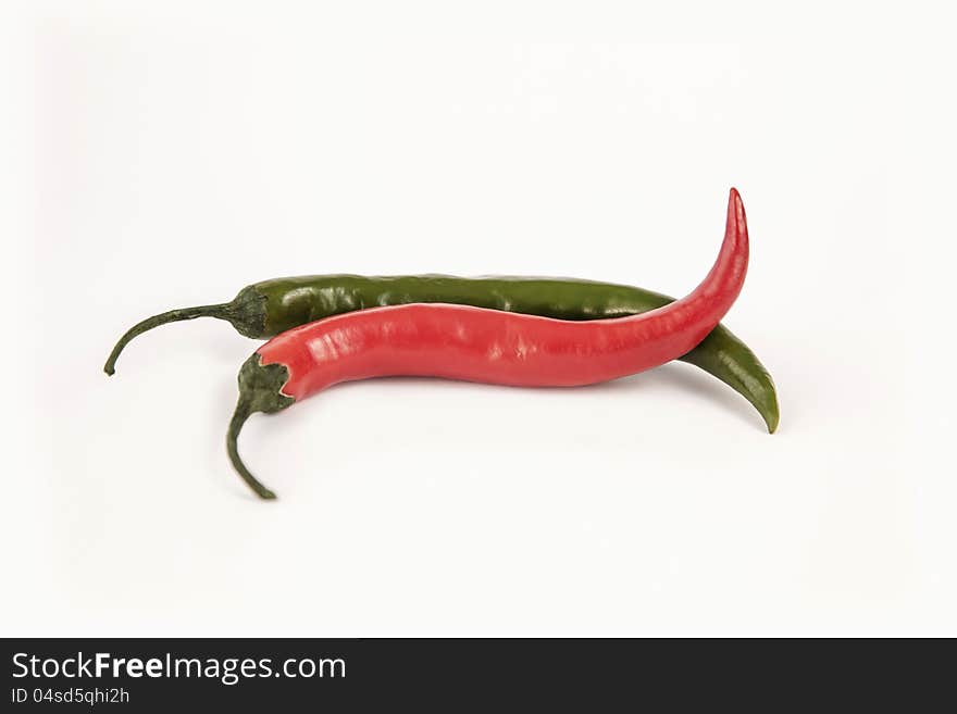 Two chilli peppers on white backgeround