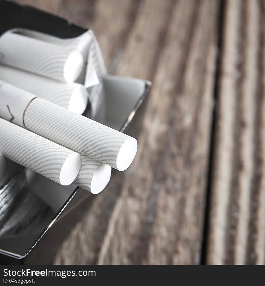 Close-up of cigarettes in pack on table