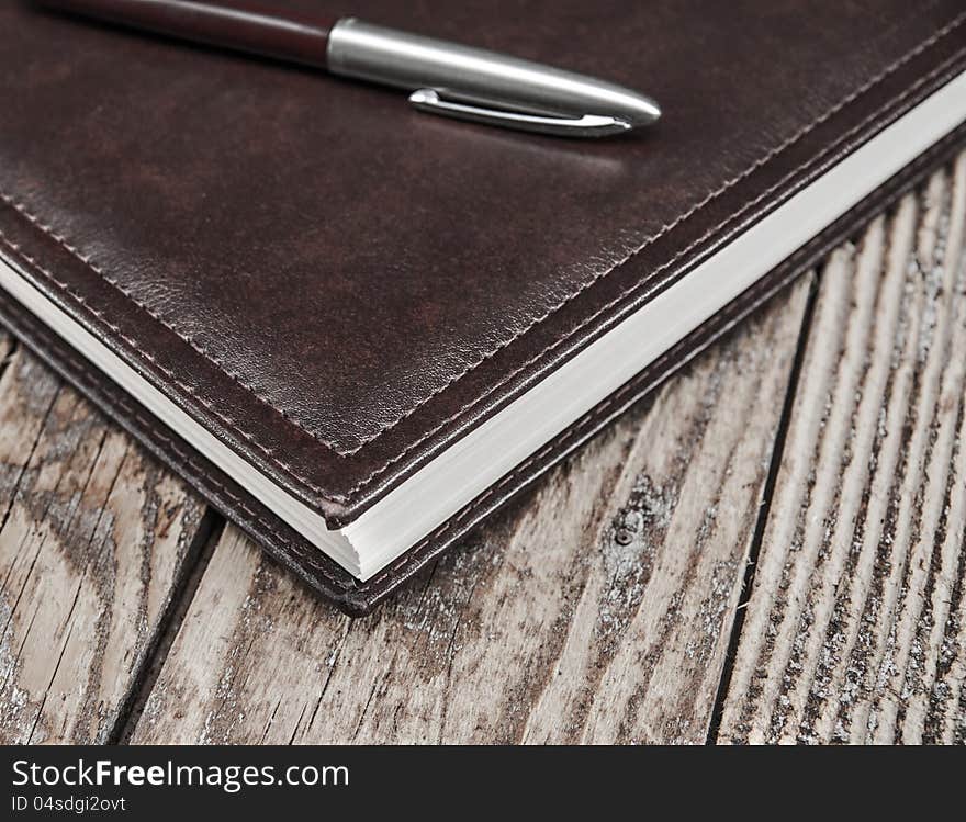 Notebook and pen  on wooden table