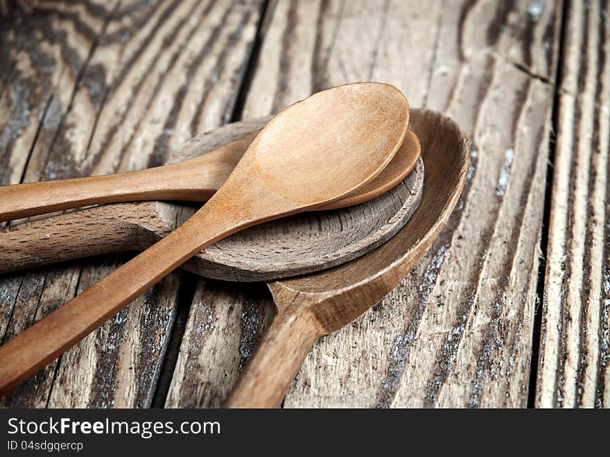 Close up of wooden spoons on wooden background