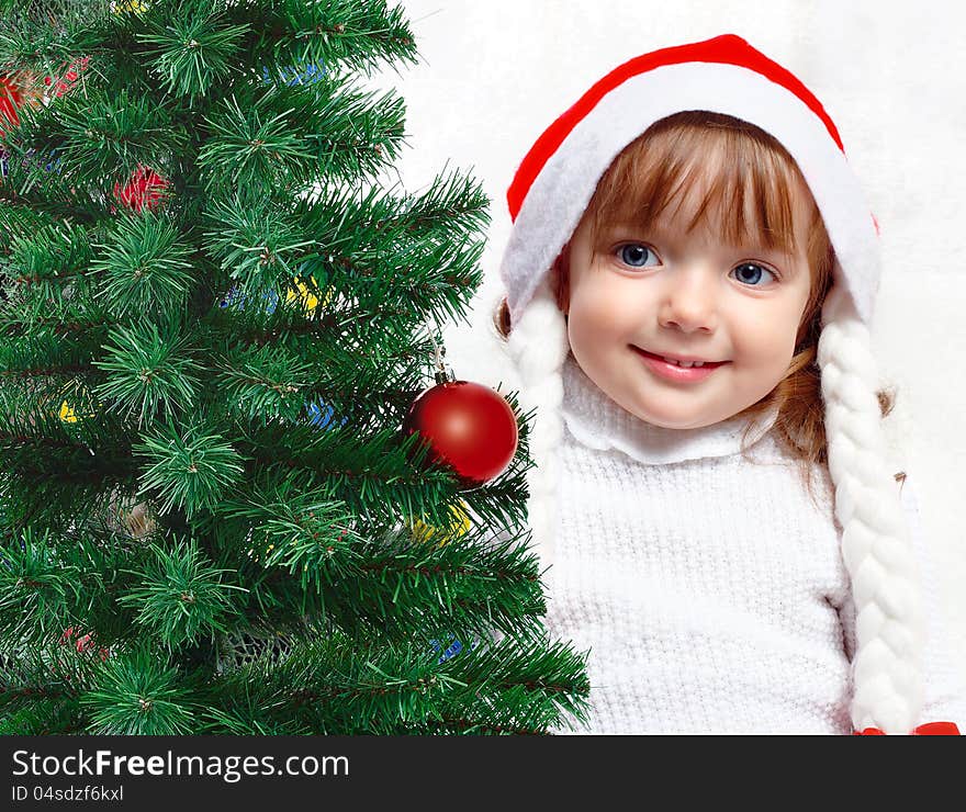 Beautiful girl dressed in a Santa Claus hat