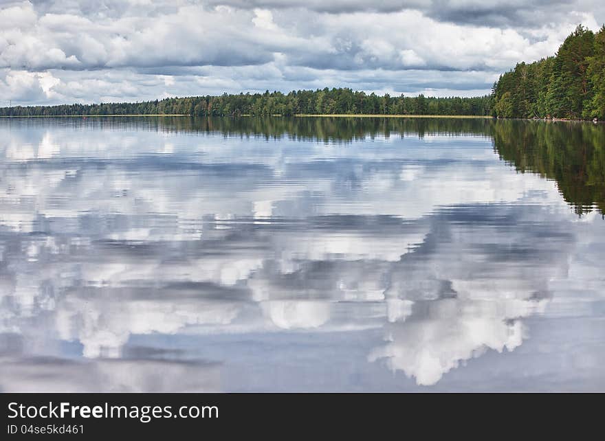 Smooth surface of the lakeThe pure lake in an environment of wood thickets. Finland