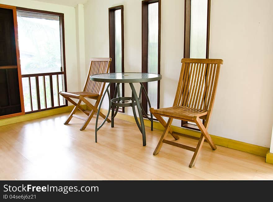 The living room is decorated with wooden chair. The living room is decorated with wooden chair.