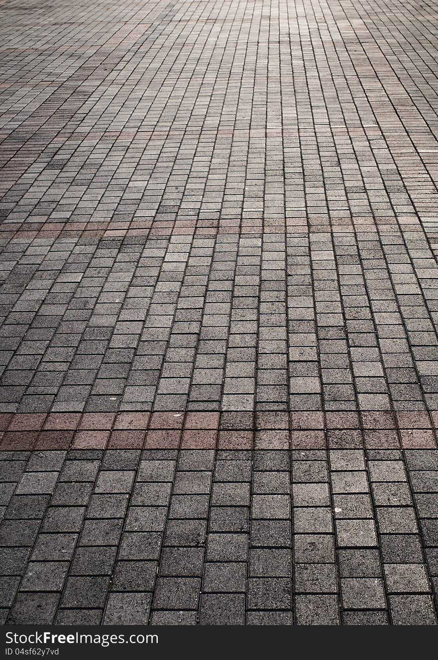 Cobblestone road with color lines in the sunlight