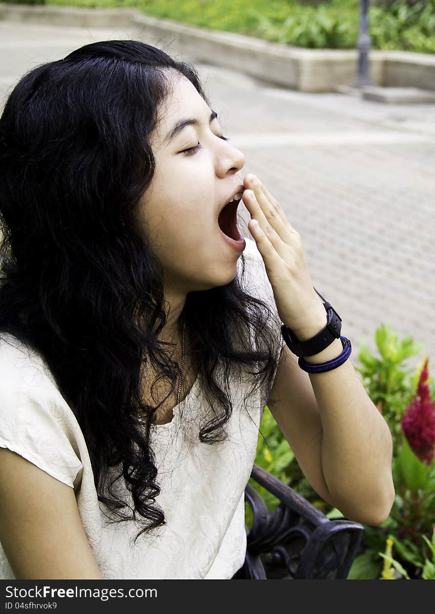 Young beautiful brunette woman yawning