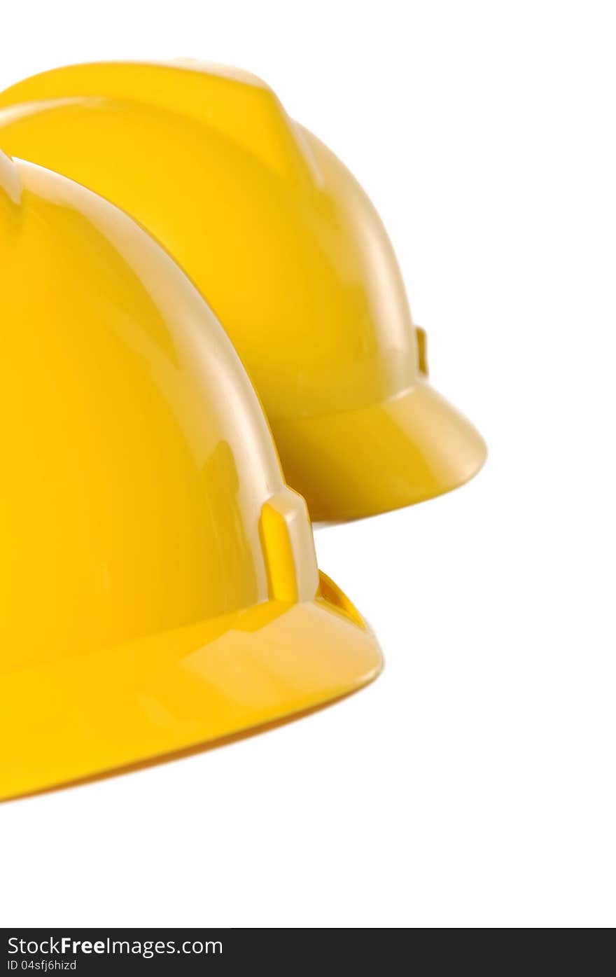 Two yellow construction helmet over white background. Two yellow construction helmet over white background