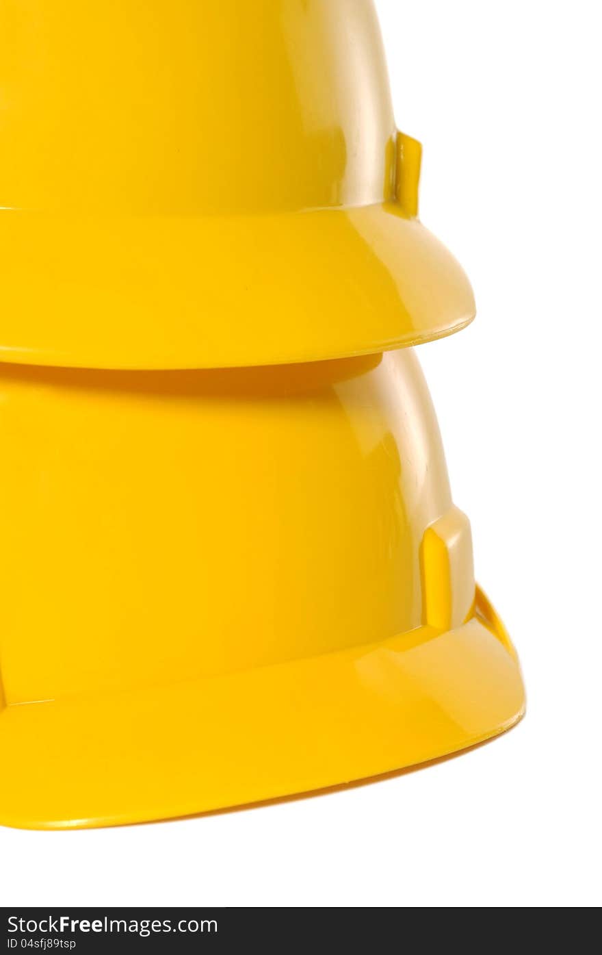 Two yellow construction helmet over white background. Two yellow construction helmet over white background