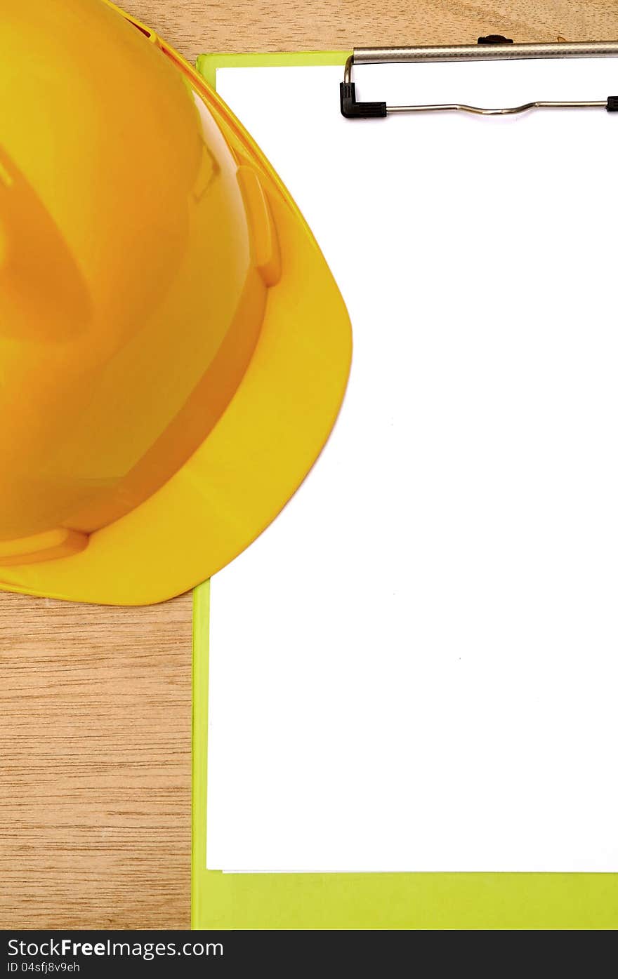 Yellow hard hat and clipboard. You can put your design on the clipboard. Yellow hard hat and clipboard. You can put your design on the clipboard