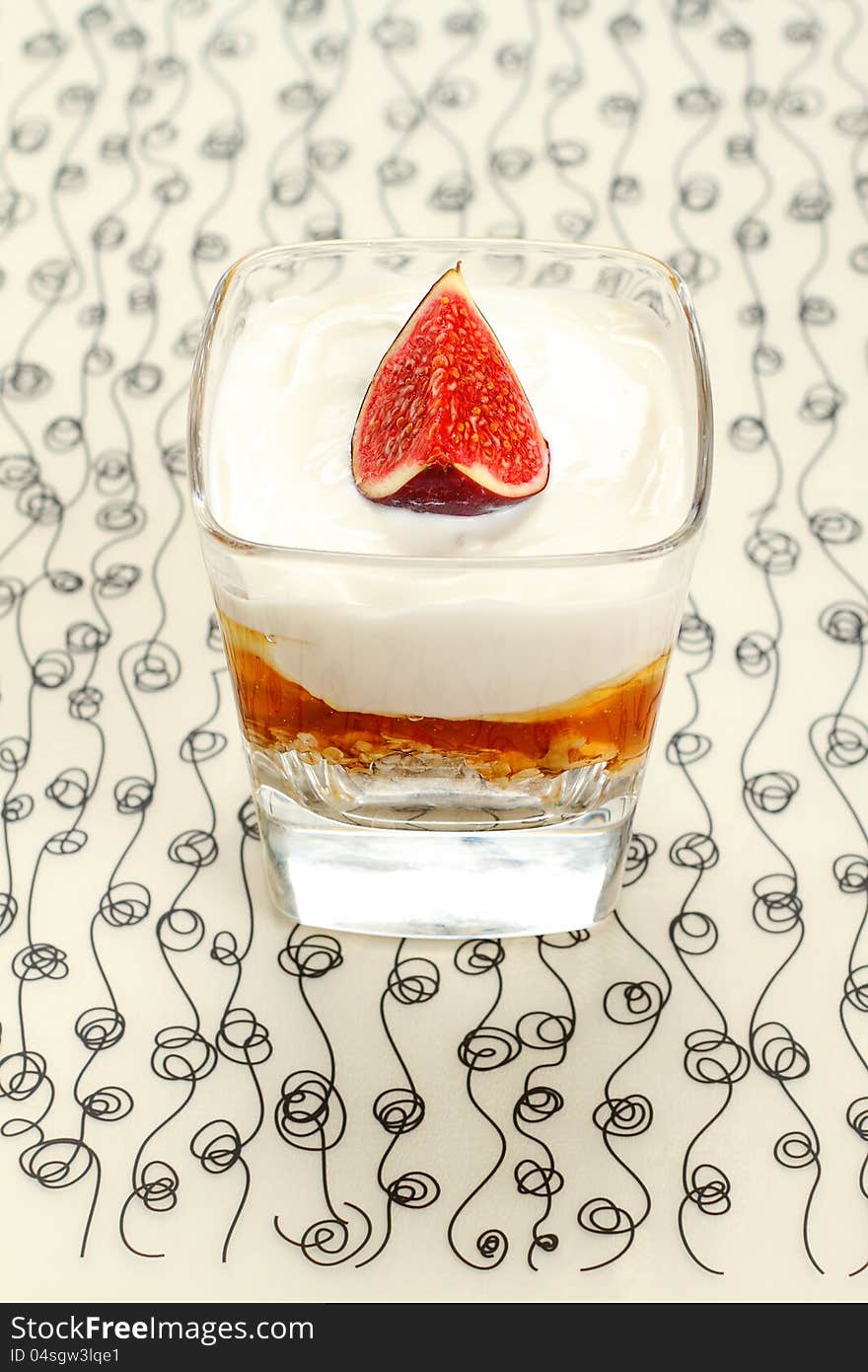 Yogurt with muesli and fig jam in a glass. Yogurt with muesli and fig jam in a glass