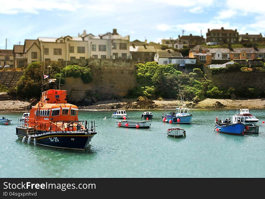 Irish village on the hill at seaside with fishing boats in foreground. Irish village on the hill at seaside with fishing boats in foreground