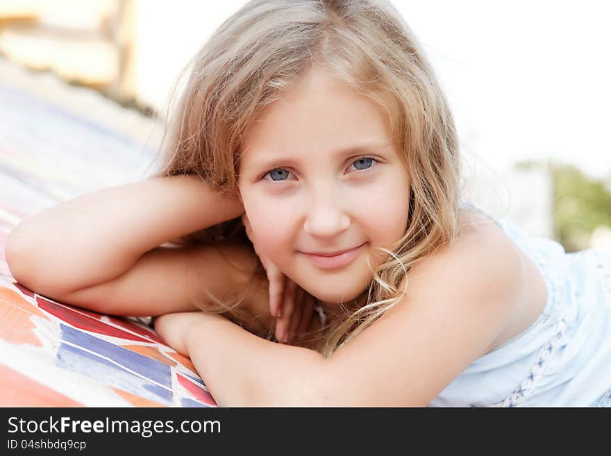 Portrait of a pretty blond  girl outside