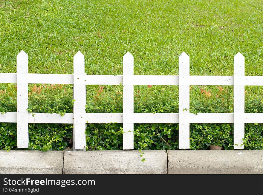 Wooden fence on a green meadow. Wooden fence on a green meadow