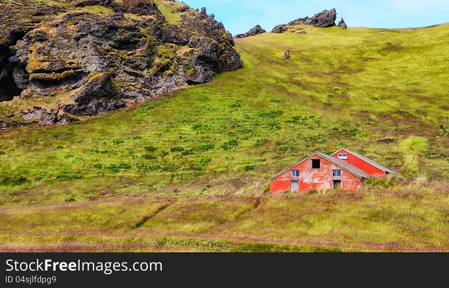 Old wooden red abandoned barn in green grass meadow, Iceland. Old wooden red abandoned barn in green grass meadow, Iceland
