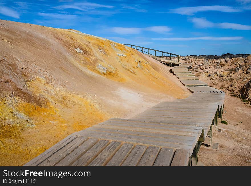 Wooden path in colorful geothermal field near Myvatn lake, Iceland. Wooden path in colorful geothermal field near Myvatn lake, Iceland