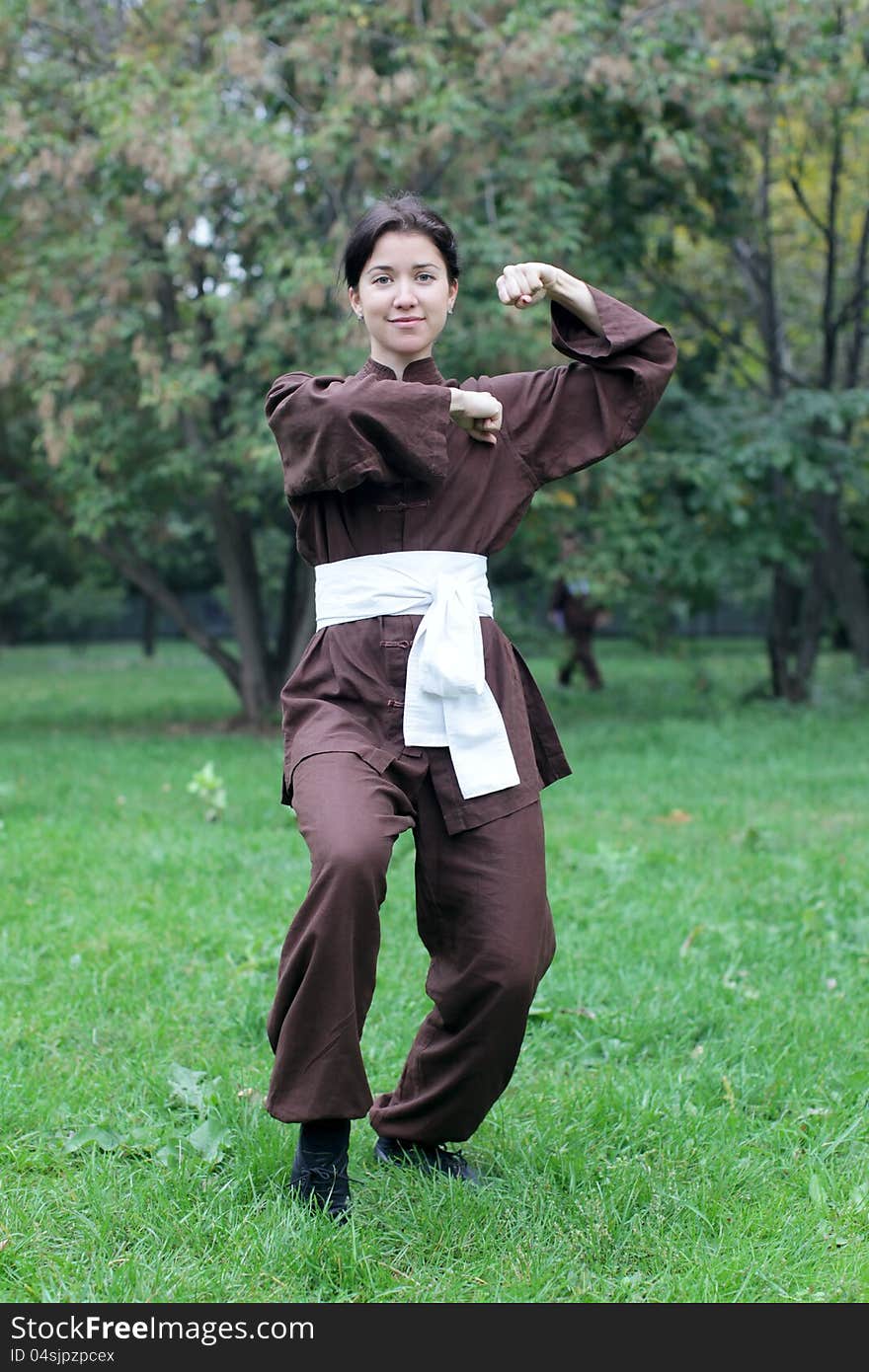 Zen pretty woman practicing exercise chi kung, tai chi or kung fu in natural park. Zen pretty woman practicing exercise chi kung, tai chi or kung fu in natural park