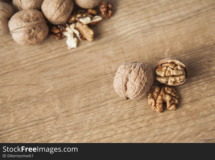 Walnuts on brown wood