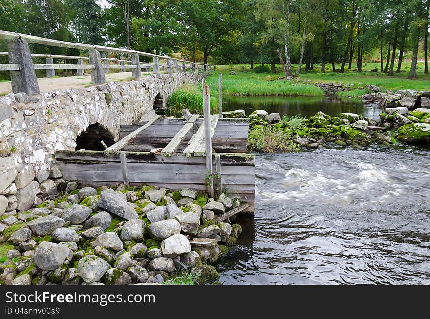 Autumn Swedish landscape with ancient bridge. Autumn Swedish landscape with ancient bridge