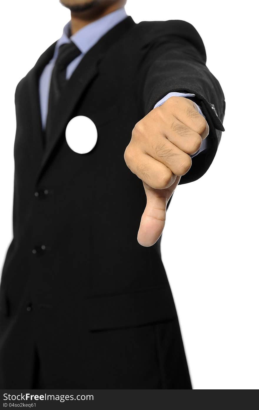 Man with black business suit with blank pinned button give thumb down. You can put your design on the button. Election day background or concept. Man with black business suit with blank pinned button give thumb down. You can put your design on the button. Election day background or concept