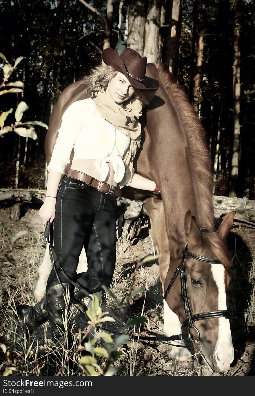 Happy cowgirl with her red horse.art toned. outdoor. Happy cowgirl with her red horse.art toned. outdoor