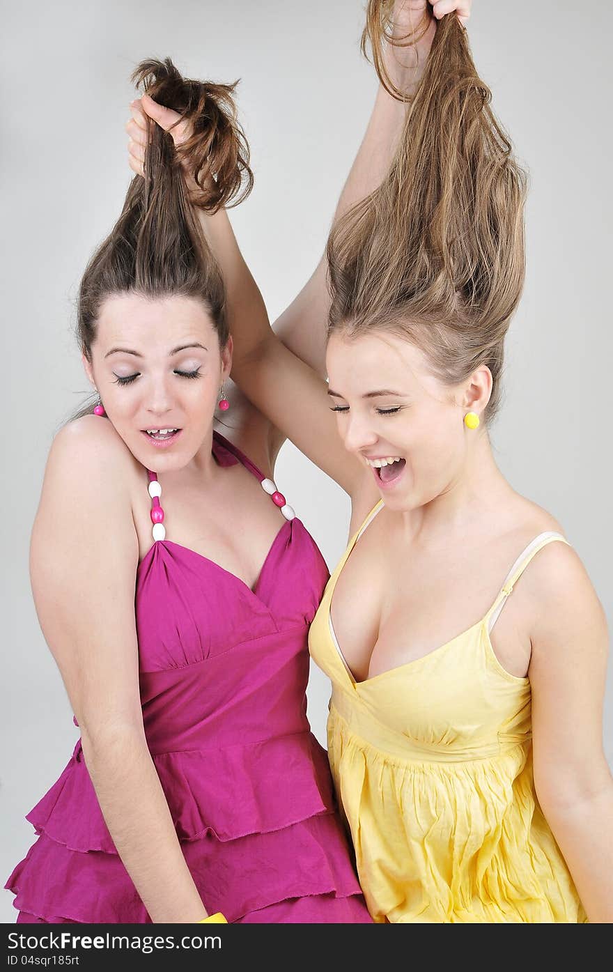 Two Funny  Girl Friends Pull Each Other S Hair.