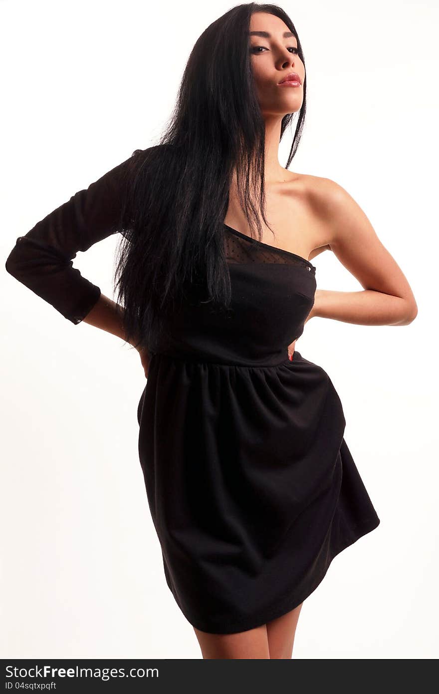 A girl dressed in a black dress on a white background. A girl dressed in a black dress on a white background.