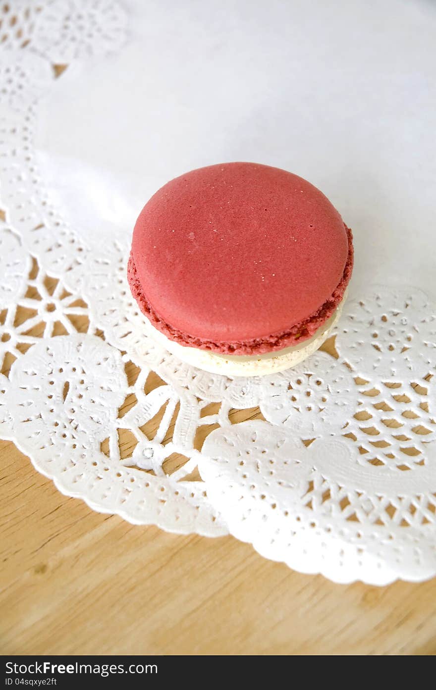 Red macaron on white curve texture. Red macaron on white curve texture