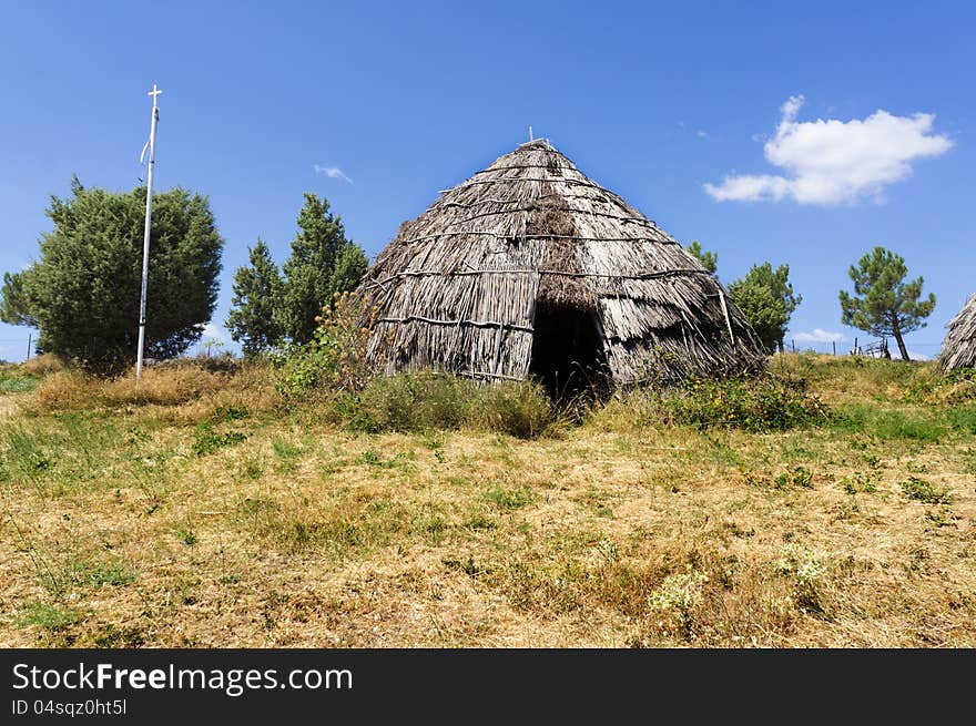 Traditional straw hut in greek country, on a sunny day