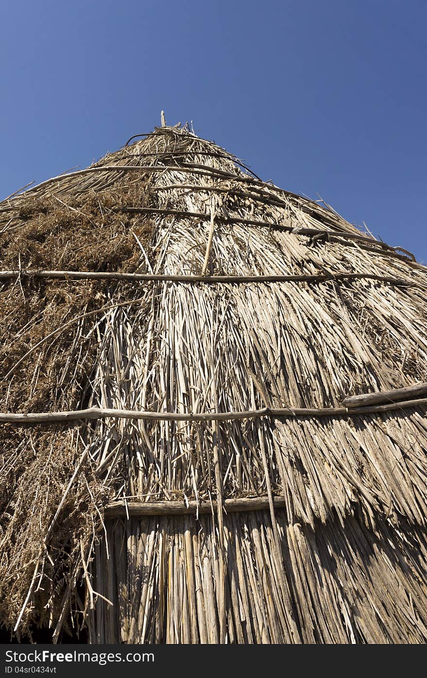 Roof of a traditional straw hut in greek country, on a sunny day