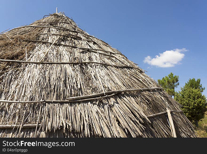 Roof of a traditional straw hut in greek country, on a sunny day