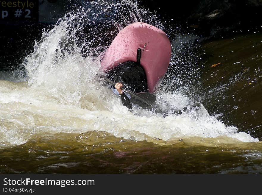 A Pink Kayak Flips As A Paddler Does His Stunts.