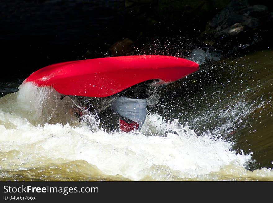 A Red Kayak Flips As A Paddler Does His Stunts.