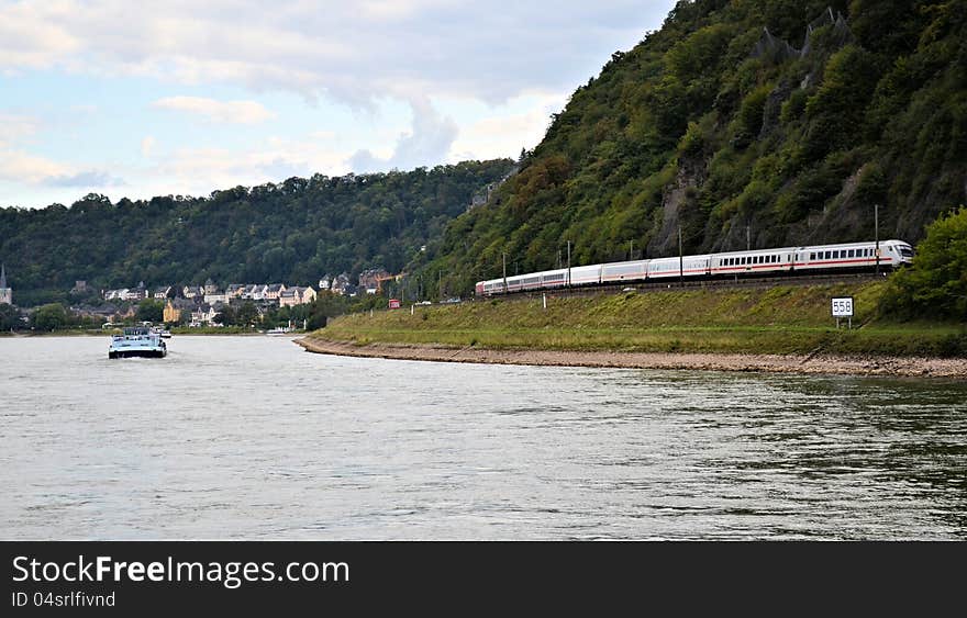 Train travelling along Rhine river