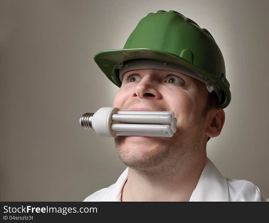 Environmental engineer with a lightbulb in his mouth. Environmental engineer with a lightbulb in his mouth