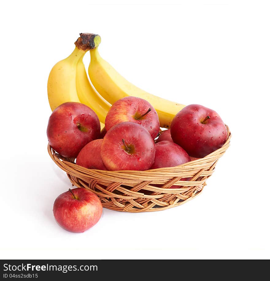 Apples and bananas  in a basket on white background