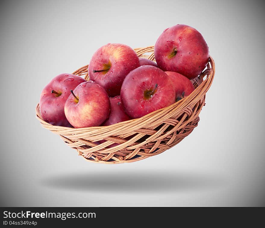 Apples in a basket on gray background. Apples in a basket on gray background