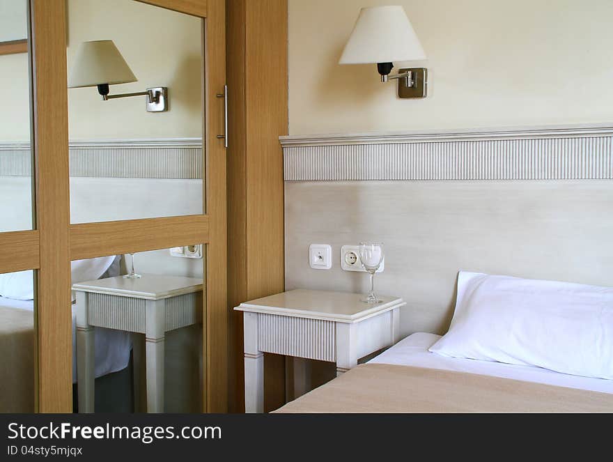 Image of a bedroom with glass on table. Image of a bedroom with glass on table