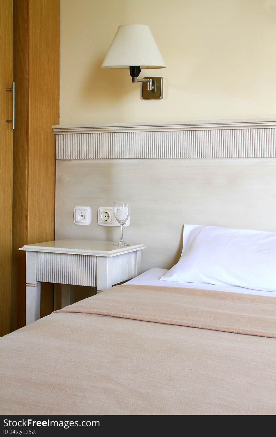 Image of a bedroom with glass on table. Image of a bedroom with glass on table