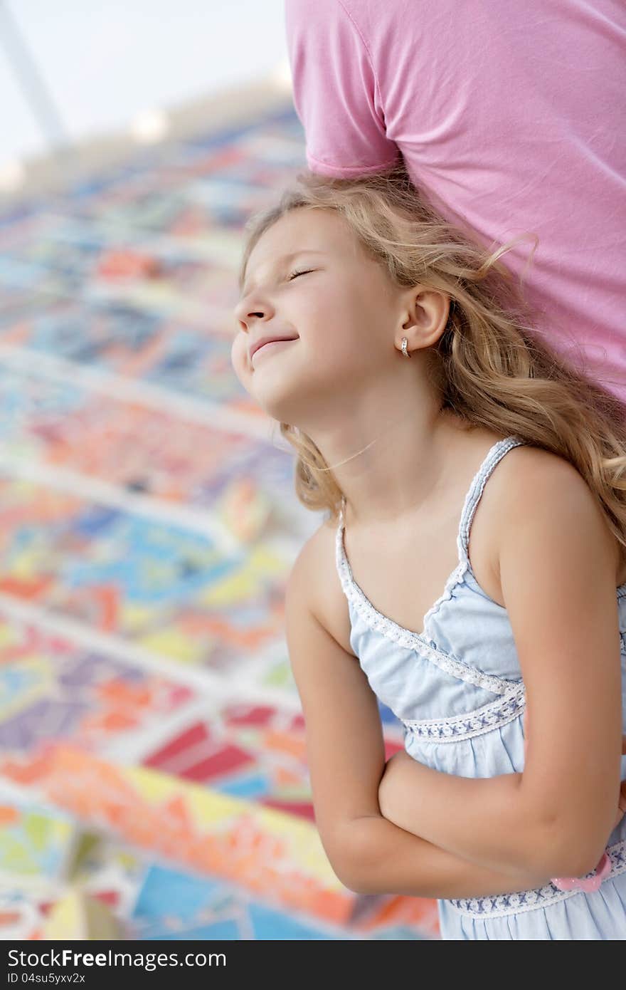 Portrait of pretty blonde girl resting on the outside