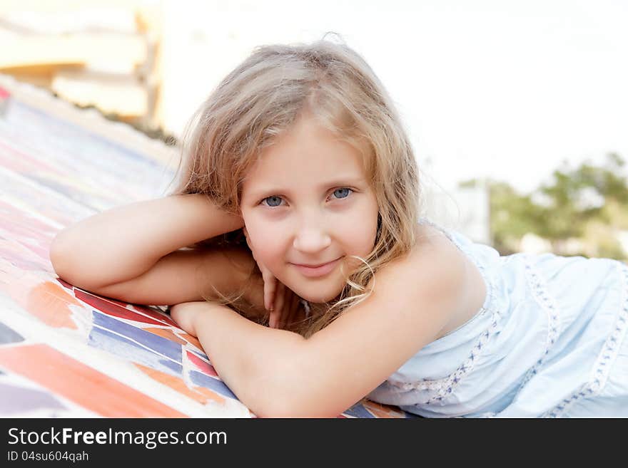 Portrait of a cute baby girl blonde on outside