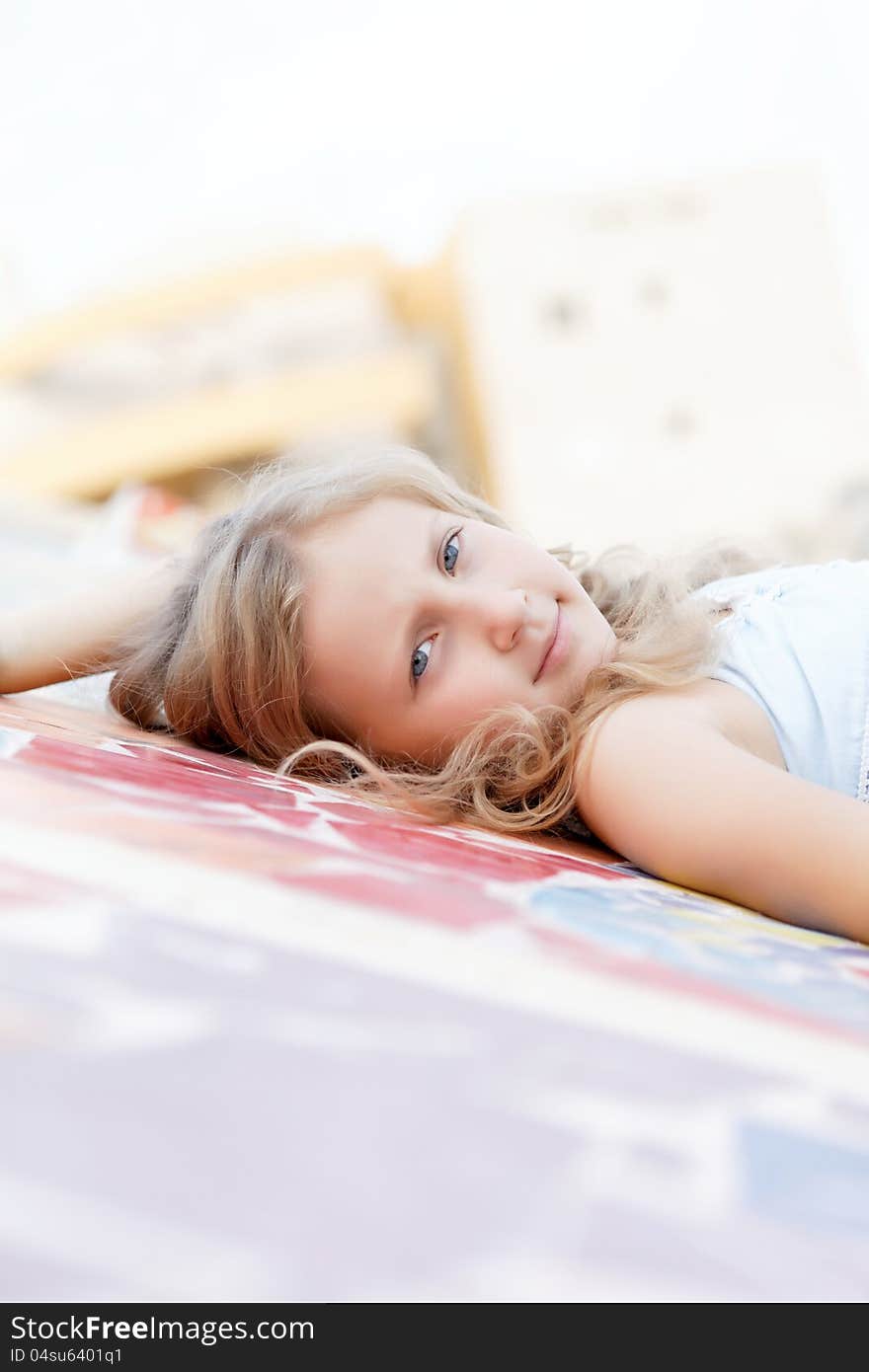 Portrait of a cute child girl blonde on outside