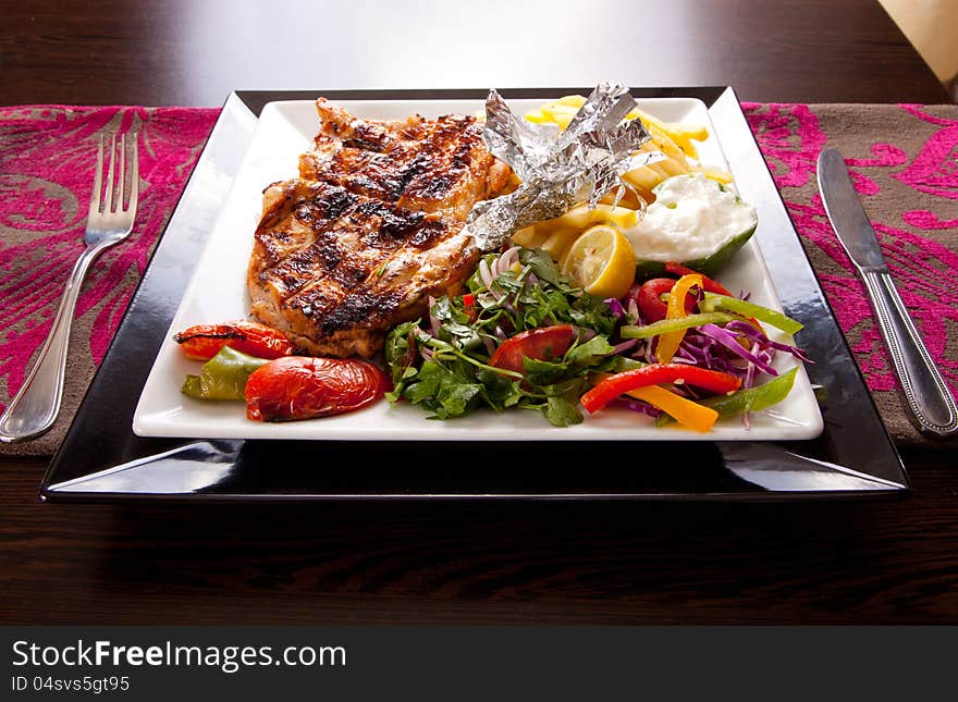 Grilled chicken with chips and vegetables. Grilled chicken with chips and vegetables