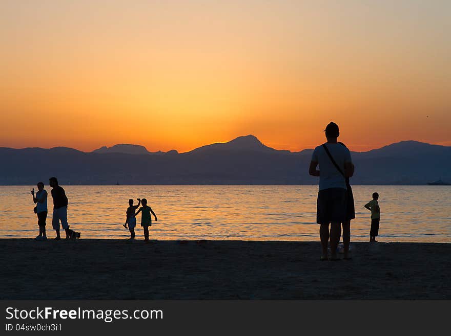 Sunset over the beach. people