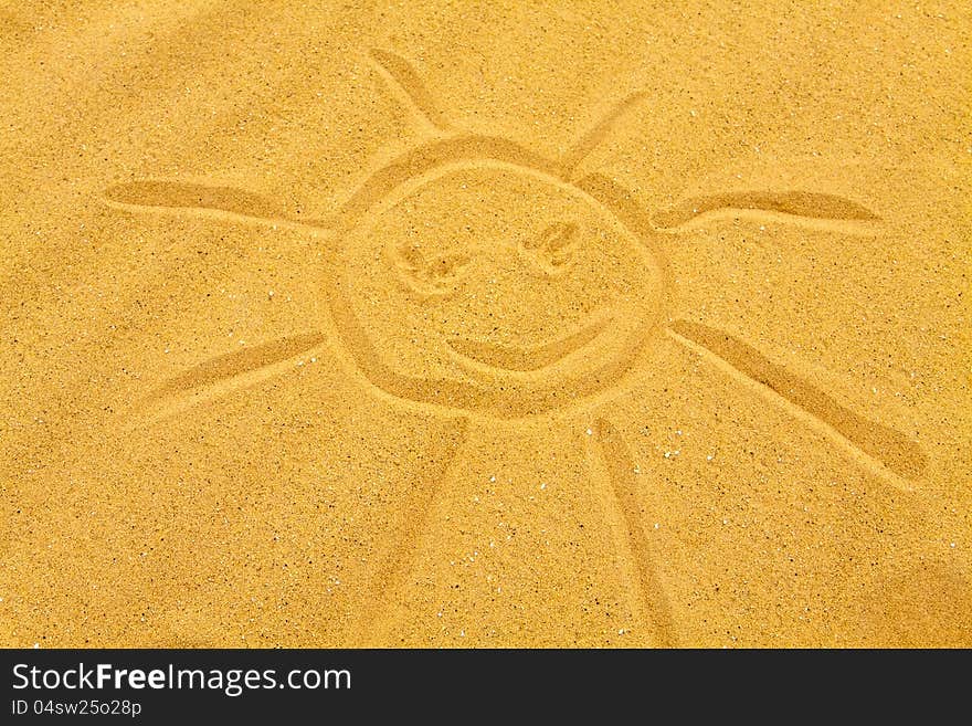 Simple sun drawn on a sandy beach. Simple sun drawn on a sandy beach