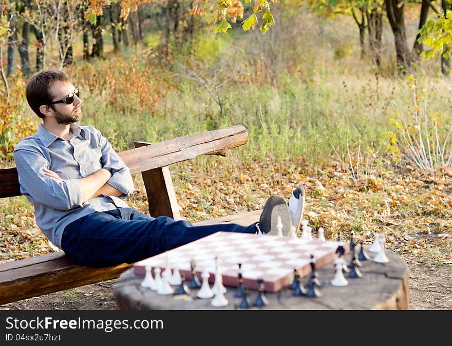 Man relaxing waiting for a chess opponent