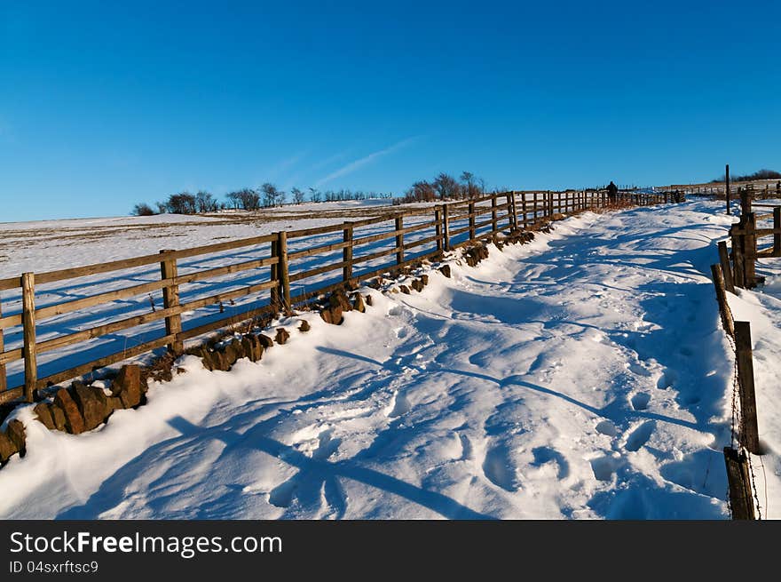 A countryside road covered with a fresh snow and a couple enjoying their walk in a snow. Image no 125. A countryside road covered with a fresh snow and a couple enjoying their walk in a snow. Image no 125.