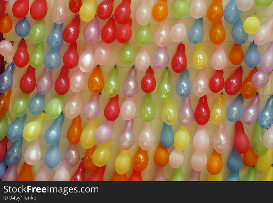 Colorful balloons on wall.