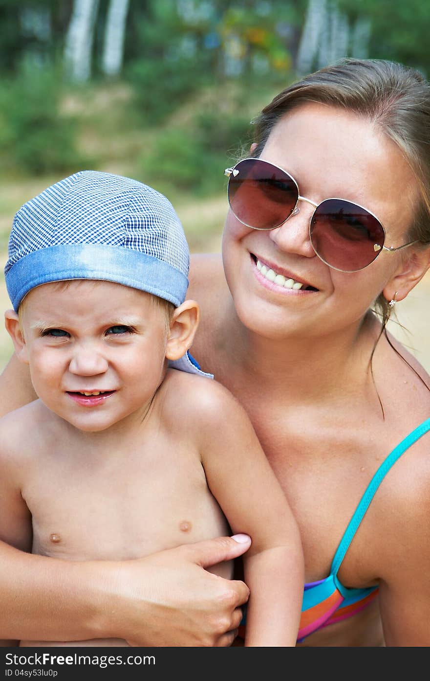 Portrait of happy mother and son on beach