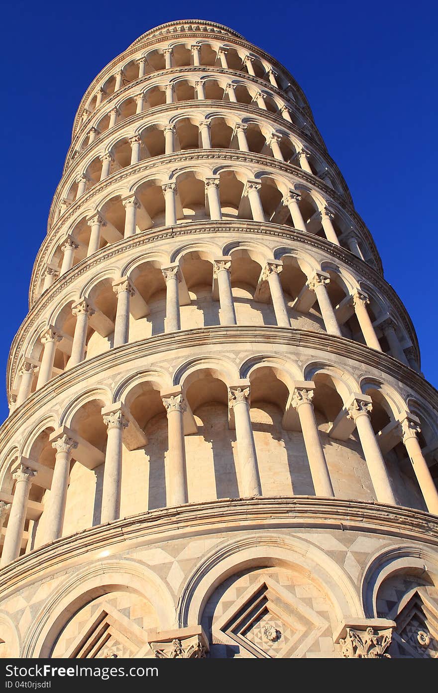 Pisa tower closeup in the morning. The clear sky is deep blue.